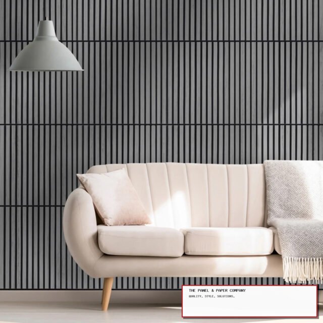 Grey 60 x 60 acoustic slatted wall panels installed behind a cream sofa